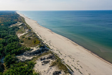 White sand beach. View to Baltic Sea Costline. Curonian Spit, Aerial view of the sea coast with waves. Travel and vacation concept.