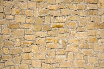 Texture of natural yellow stone brick wall