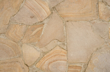 Sandstone flagstone texture, paved road. Beige seamless background