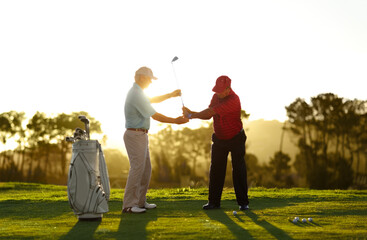 Keep the club level right through your swing. A male golfer receiving help from his caddy on the...