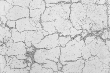 Cracks on white concrete surface cracked weathered cement worn texture broken abstract damaged pattern background