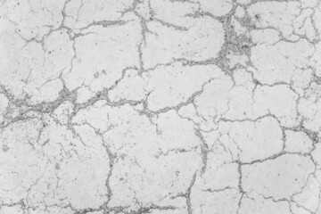 Cracks on white concrete surface cracked weathered cement worn texture broken abstract damaged pattern background