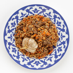 Oriental Uzbek cuisine dish in traditional plate