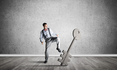 Breaking through access concept with man in room crashing concrete key