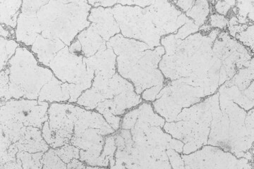 Cracks on white concrete surface cracked weathered cement worn texture broken abstract damaged pattern background
