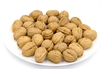 Bowl of walnuts on white background