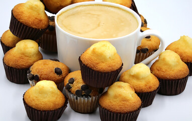 Breakfast cup surrounded by cupcakes everywhere