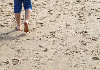 Child walking along the beach