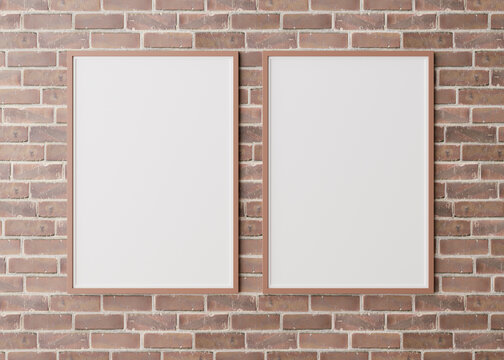 Two blank vertical picture frames hanging on brown brick wall. Template, mock up for your picture or poster. Copy space. 3D rendering.