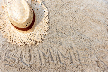 Summer Travel.  Writing summer on the sand beach with vintage hat for  relax on the beautiful beach...