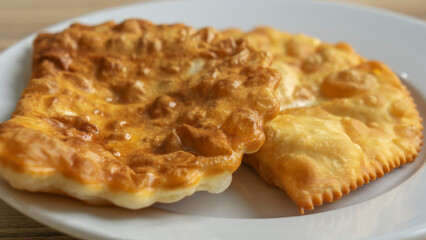 Homemade pasties with meat filling on white plate. traditional Caucasian and Russian cuisine. Take away food concepts