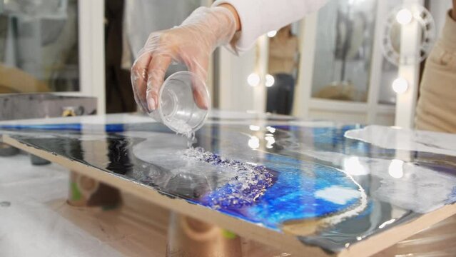 Adding texture with clear pieces to an epoxy resin painting