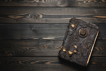 Magic book on the wooden desk table flat lay background with copy space.