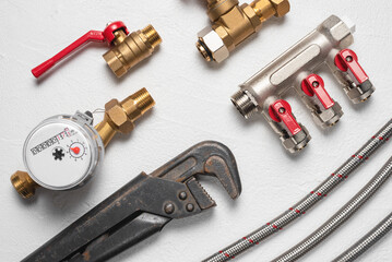 Plumbing equpment and accessories parts on the white flat lay background. Pipeline parts and wrench.