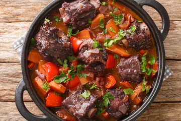 Beef tail oxtail stew cooked in traditional spanish food rabo de toro closeup on a pot on the...