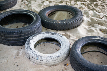 Old tires for people to play with on the beach
