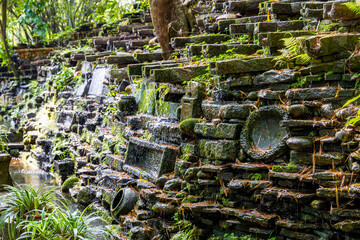 The flowing water sculpture landscape composed of many stone grinding discs in the park