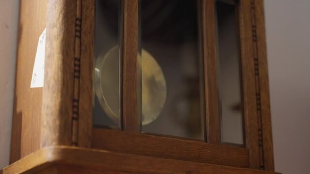 Push in shot of wall clock pendulum