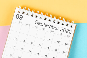 September 2022 desk calendar on multicolored background.