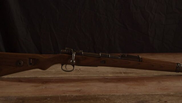 Dolly out of old Kar98 Mauser rifle standing on a wooden surface
