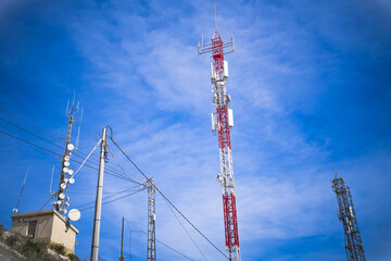 telecommunication masts with mobile phone antennas on the blu sky