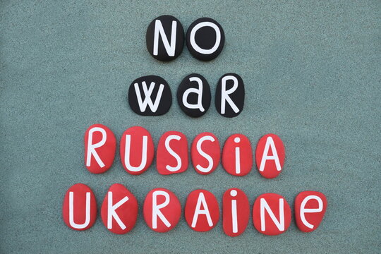 No war, Russia and Ukraine, creative slogan composed with colored stone letters over green sand
