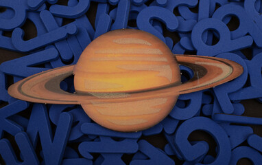 Isolated model of planet Saturn isolated on words education concept