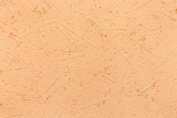 Orange paint on chipboard surface, pressed wood texture abstract osb background