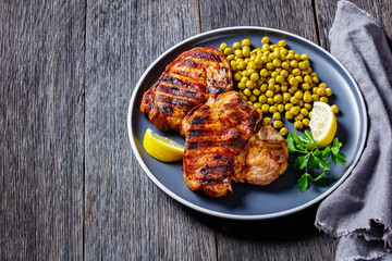 grilled pork t-bone steaks with boiled green peas
