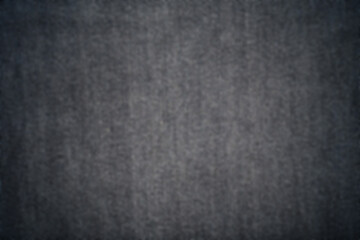Blur Texture of Black Denim jeans fabric background .