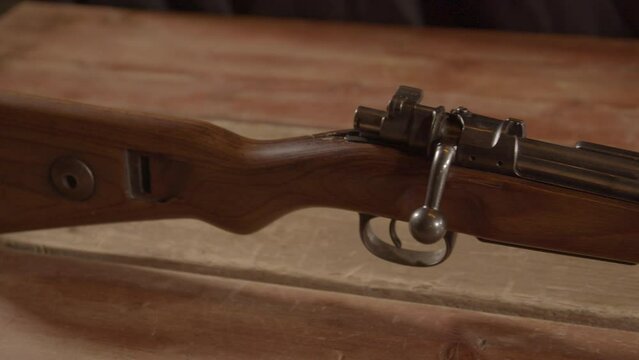 Dolly out from buttstock revealing old Kar98 Mauser rifle