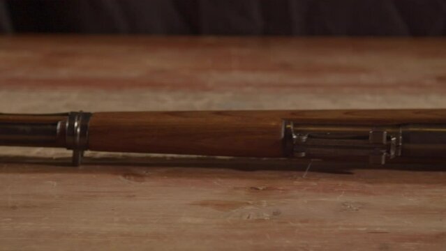 Dolly of old K98 Mauser rifle lying on a wooden surface