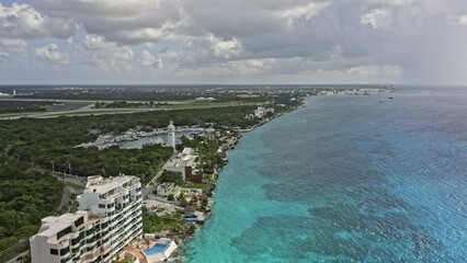 Cozumel Mexico Aerial v18 panoramic circular pan shot capturing beautiful turquoise caribbean sea and resorts along the shore with international airport in close distance - September 2020