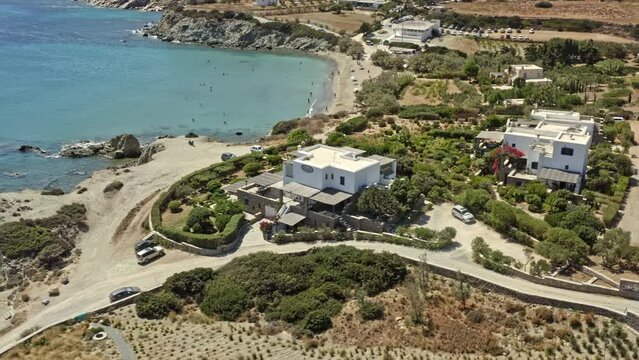 Paros Greece Aerial v5 birds eye view drone fly around capturing sparse coastal homes and secluded paralia lolantonis beach with beautiful aegean sea and hilly background - September 2021