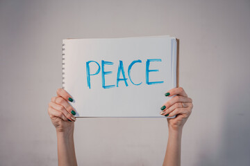 Protest poster with the inscription For peace. Women's hands