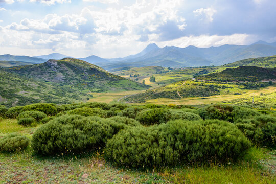 Mountainous valley with small village and green fields