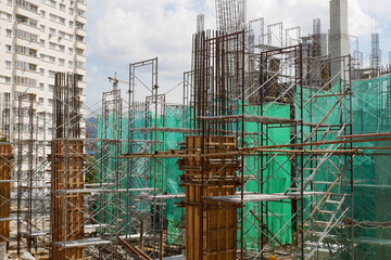 SELANGOR, MALAYSIA -JULY 17, 2021: Concrete columns are formed using timber and plywood formwork. Steel reinforcement is neatly installed inside before being poured with molten concrete.