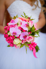 Wedding dress and bridal bouquet with beautiful flowers. Husband and wife bride, happy together, just married
