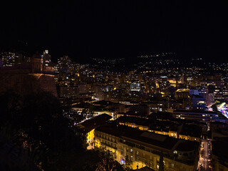 Night view of downtown district La Condamine in the center of Monaco at the mediterranean coast with illuminated skyline of residential buildings.