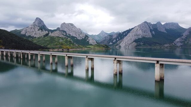 Ria&ntilde;o, Castile and Leon, Spain - Aerial Drone View of the Famous Bridge, Water Reservoir and Cloudy Mountains