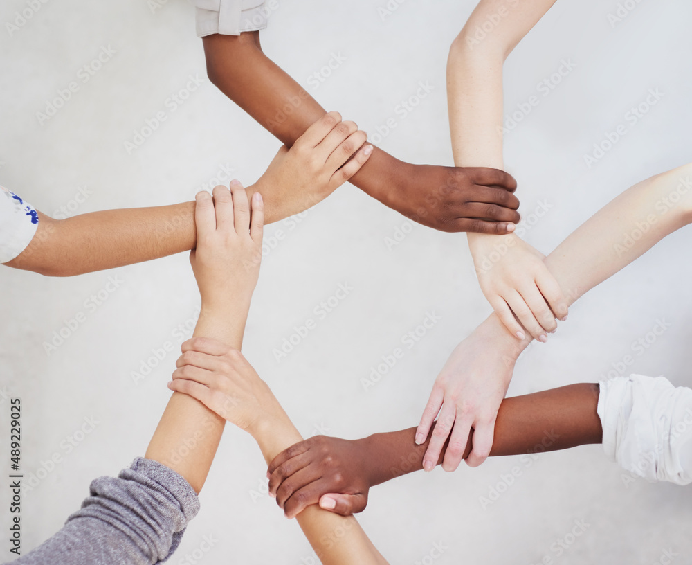 Poster Connected as one. Shot of a group of hands holding on to each other.