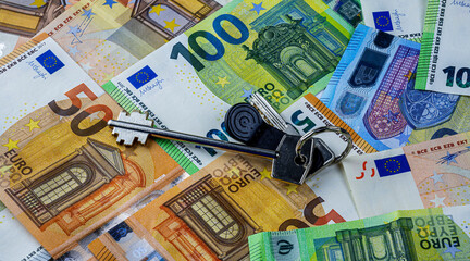 key of room or flat on a euro money banknotes background , real estate market concept design