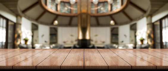 Empty wooden table top with lights bokeh on blur restaurant background.