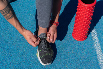 Man tying sneakers. Training Day. Sportswear