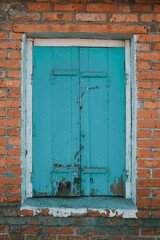 Wooden rustic antique window and brick wall. Vertical shot