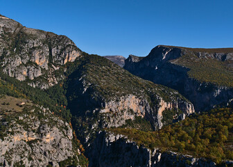 Stunning view of majestic ravine Verdon Gorge (Gorges du Verdon) in Provence region in southern France on sunny day in autumn season with rugged rocks.