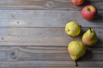 fresh apples and pears on wooden background