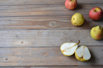 fresh apples and pears on wooden background