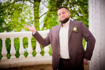 Newly wedded man in the park. Just married in day of him wedding. Happy groom in summer day