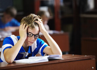 I just cant get this right - Learning disabilities. Young boy feeling overcome with boredom in the...